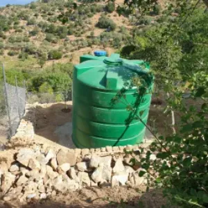 Why are water tanks typically positioned at elevated locations?